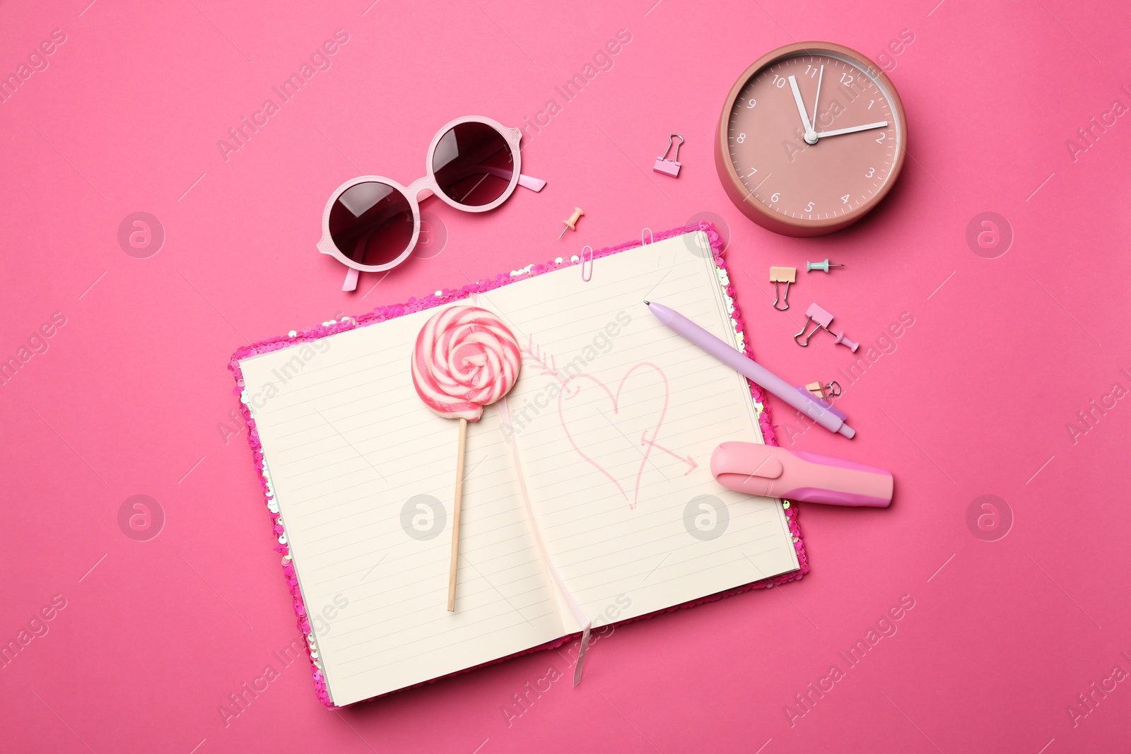 Photo of Flat lay composition with heart drawn in notebook on pink background