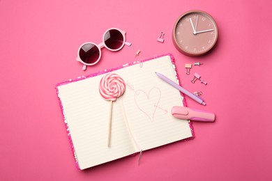 Flat lay composition with heart drawn in notebook on pink background