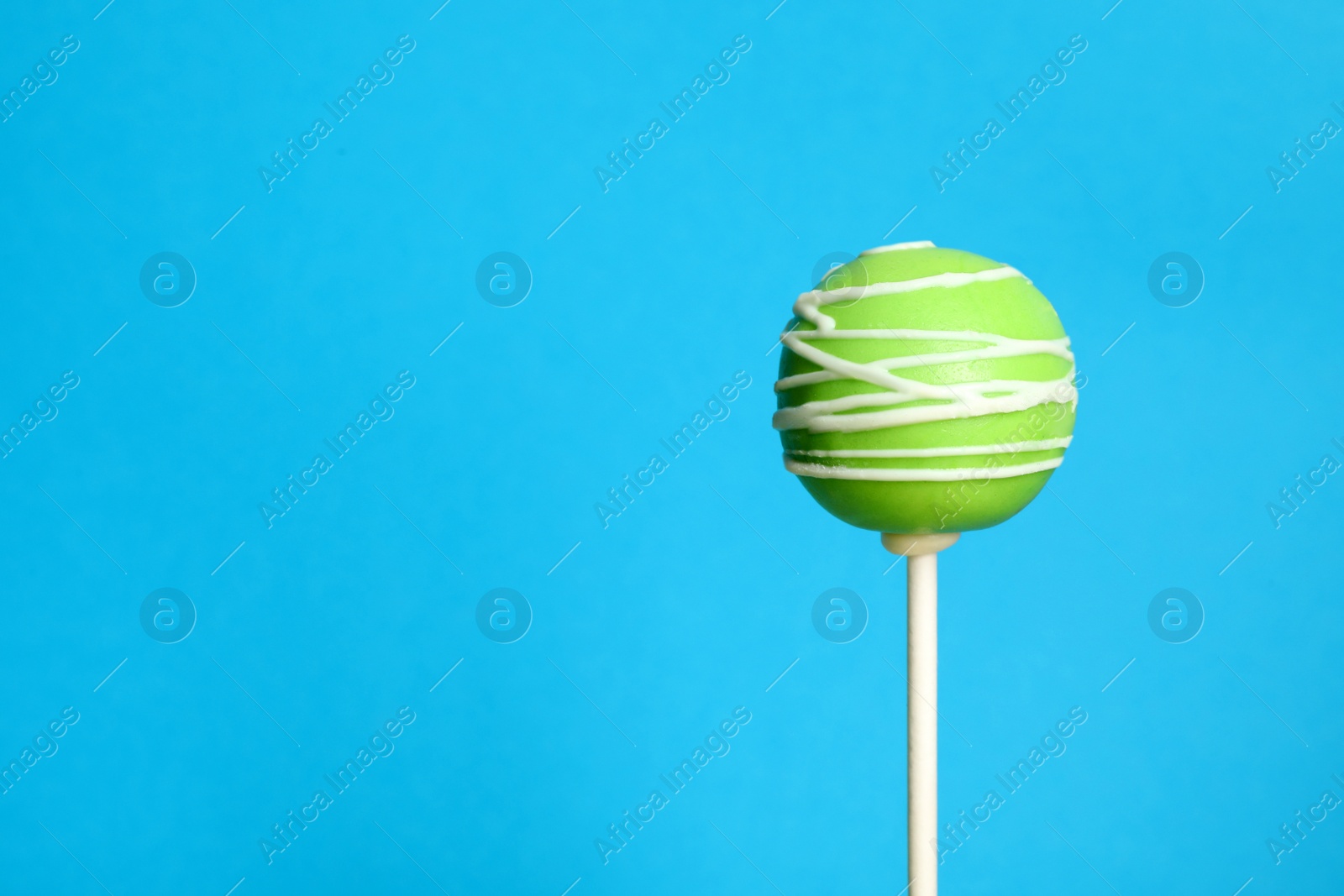 Photo of Bright delicious cake pop on color background. Space for text