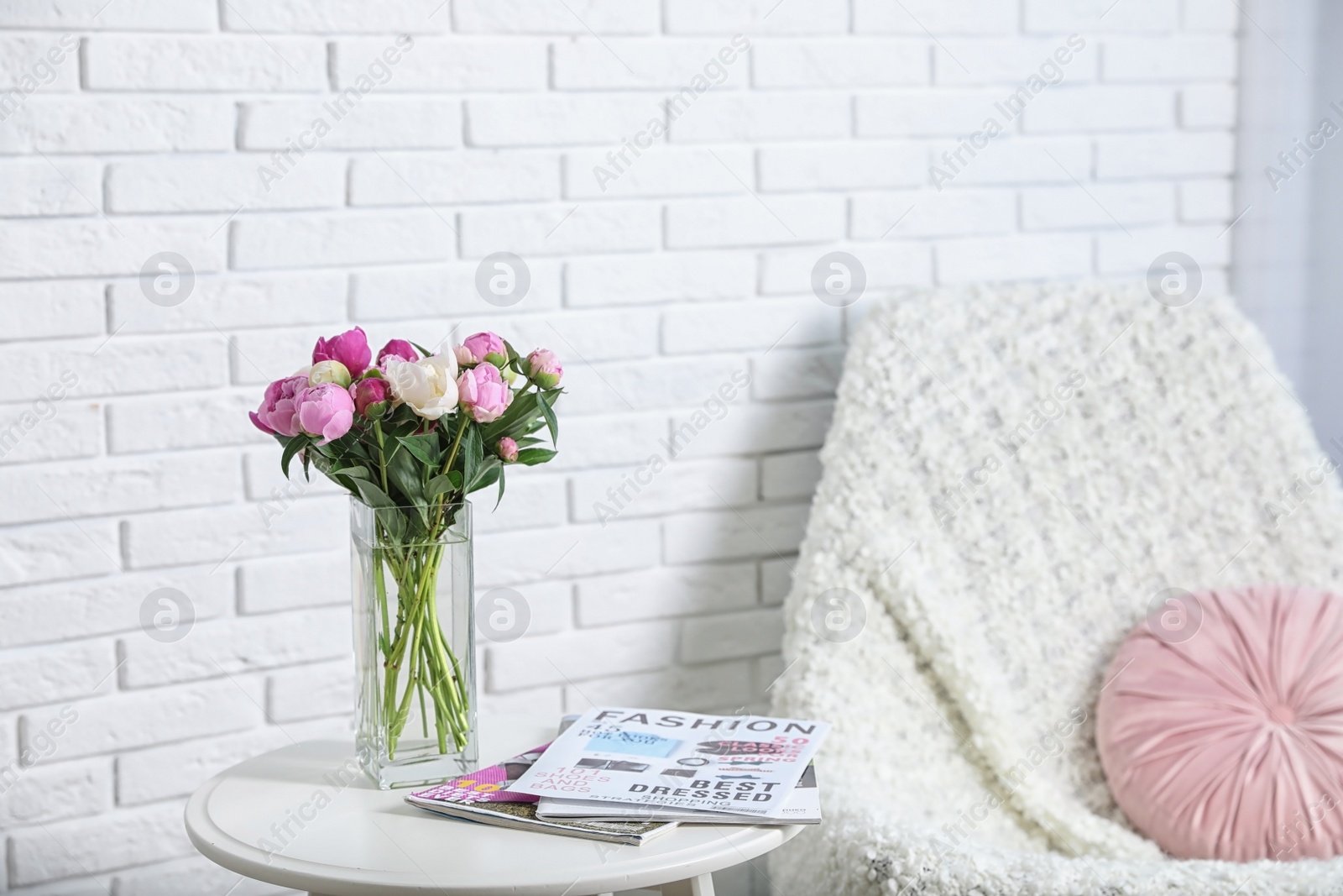 Photo of Vase with bouquet of beautiful peonies on table in room, space for text