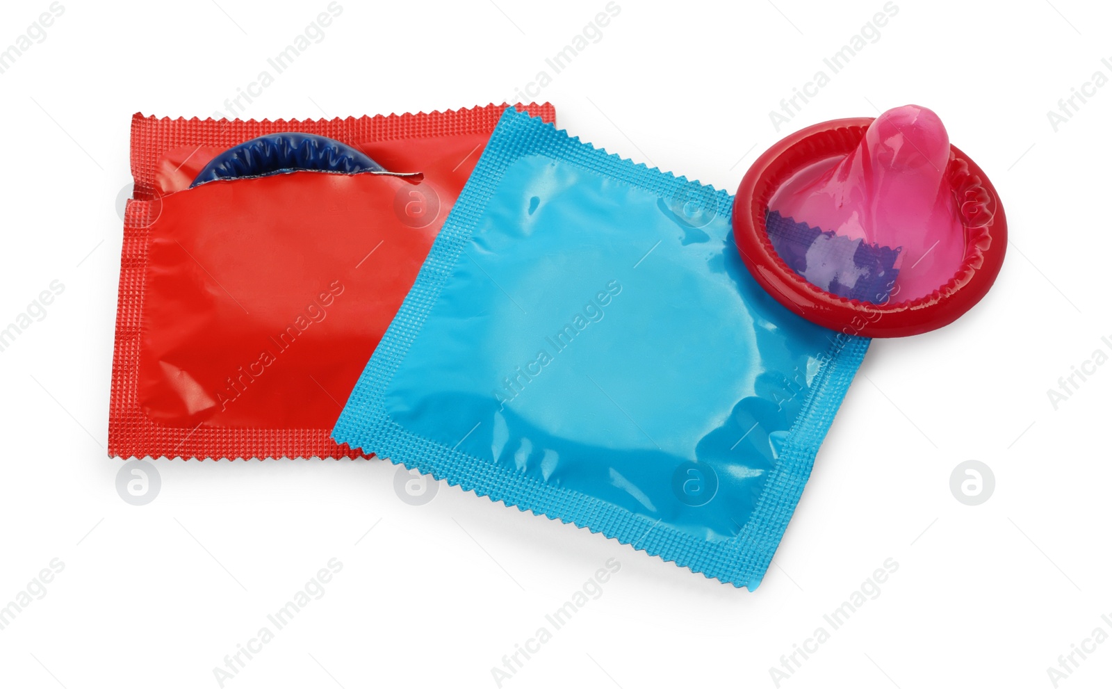 Photo of Unwrapped and packaged condoms on white background. Safe sex