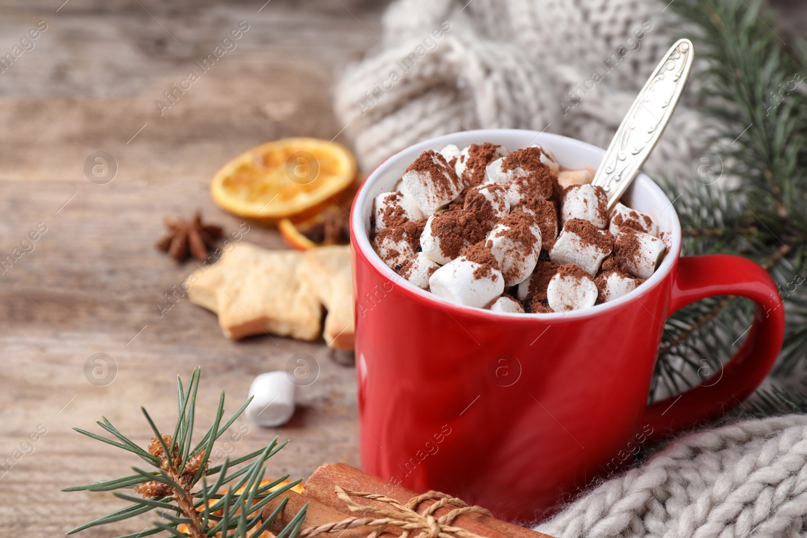 Photo of Composition of tasty cocoa with marshmallows in cup on wooden table. Space for text
