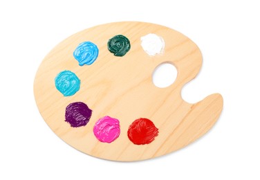 Photo of Wooden artist's palette with samples of paints isolated on white, top view