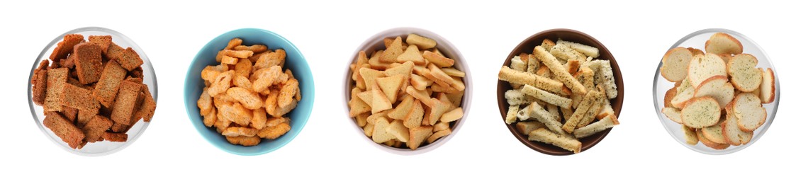 Image of Set with different delicious crispy rusks on white background, top view. Banner design