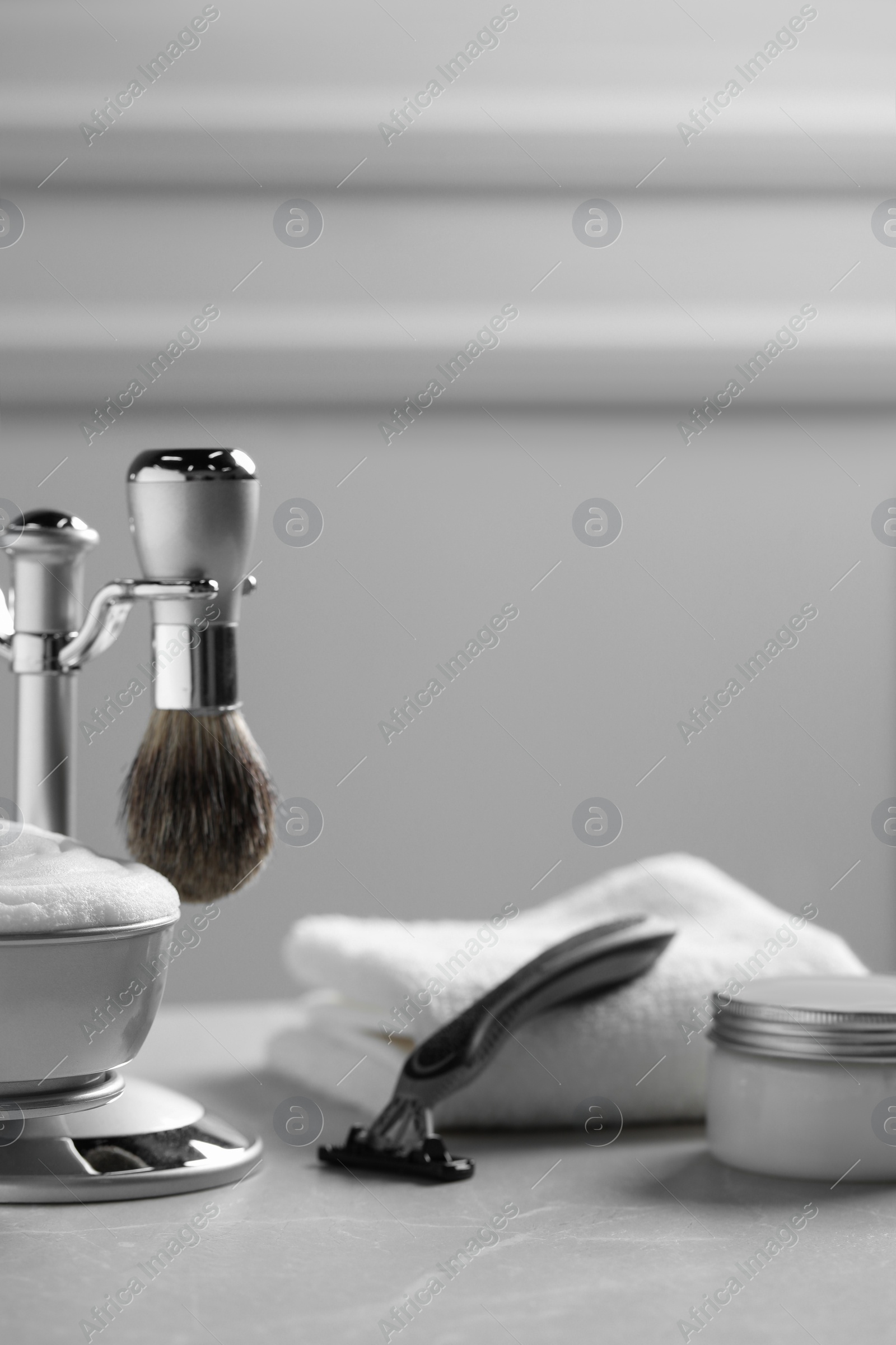 Photo of Set of men's shaving tools on grey table. Space for text