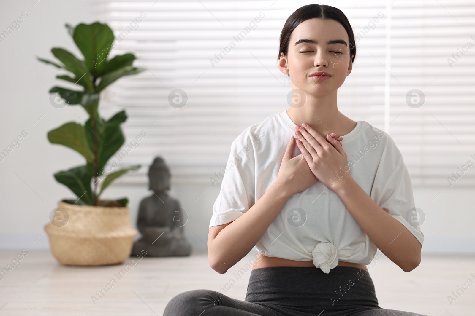 Photo of Portrait of beautiful girl meditating in yoga studio