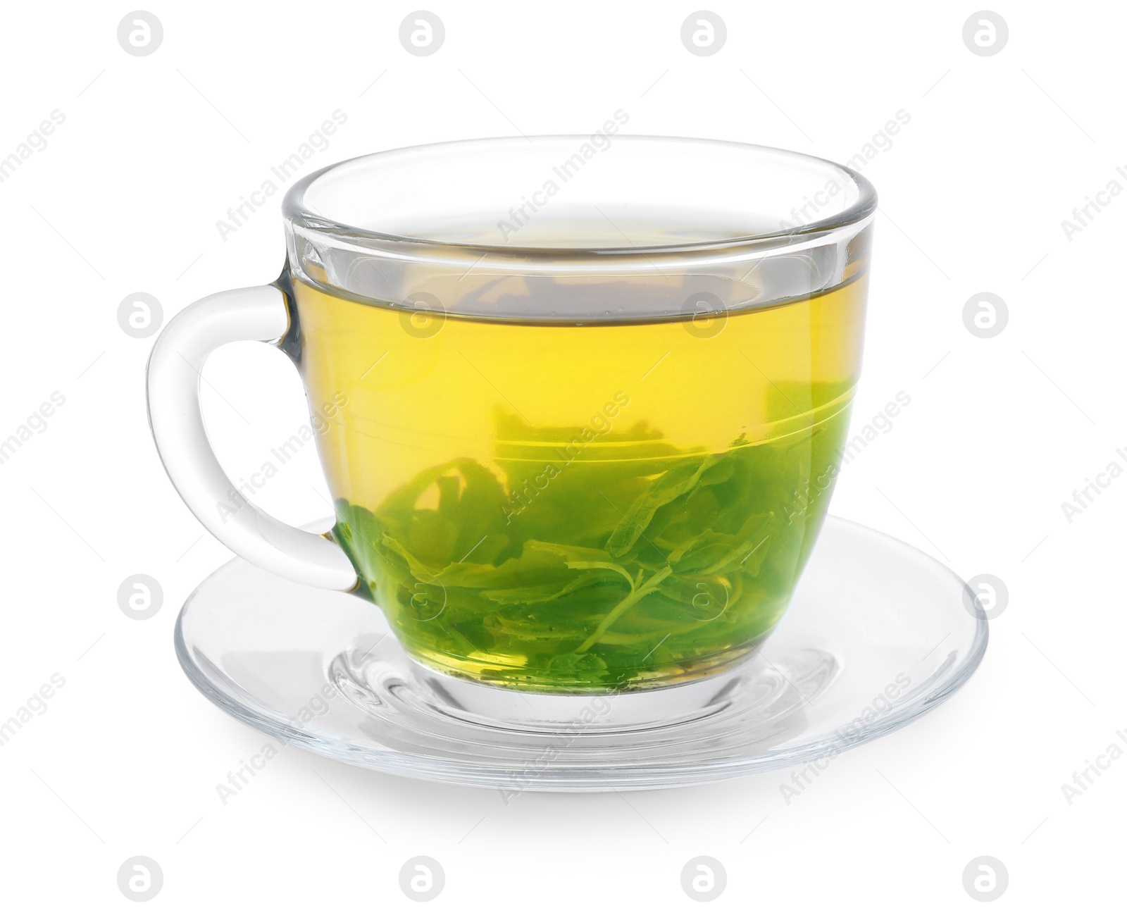 Photo of Fresh green tea in glass cup, leaves and saucer isolated on white