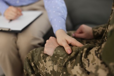 Photo of Psychotherapist working with military woman in office, closeup