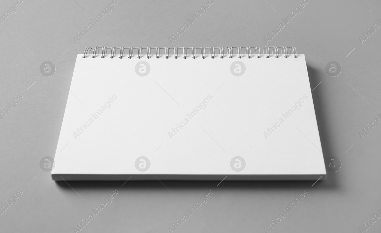 Photo of Blank notebook on grey background. Mockup for design