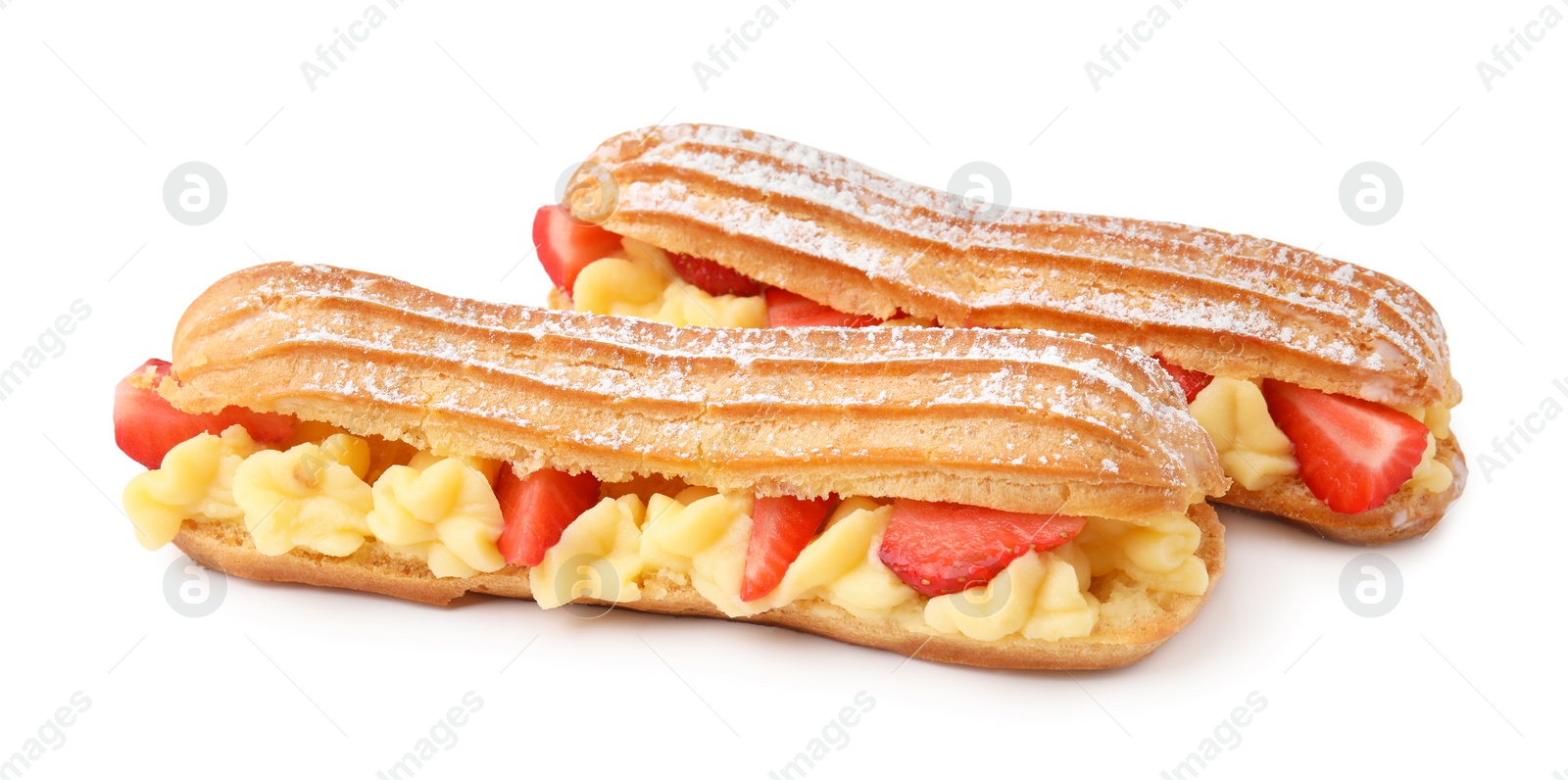 Photo of Delicious eclairs filled with cream and strawberries isolated on white