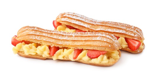 Photo of Delicious eclairs filled with cream and strawberries isolated on white