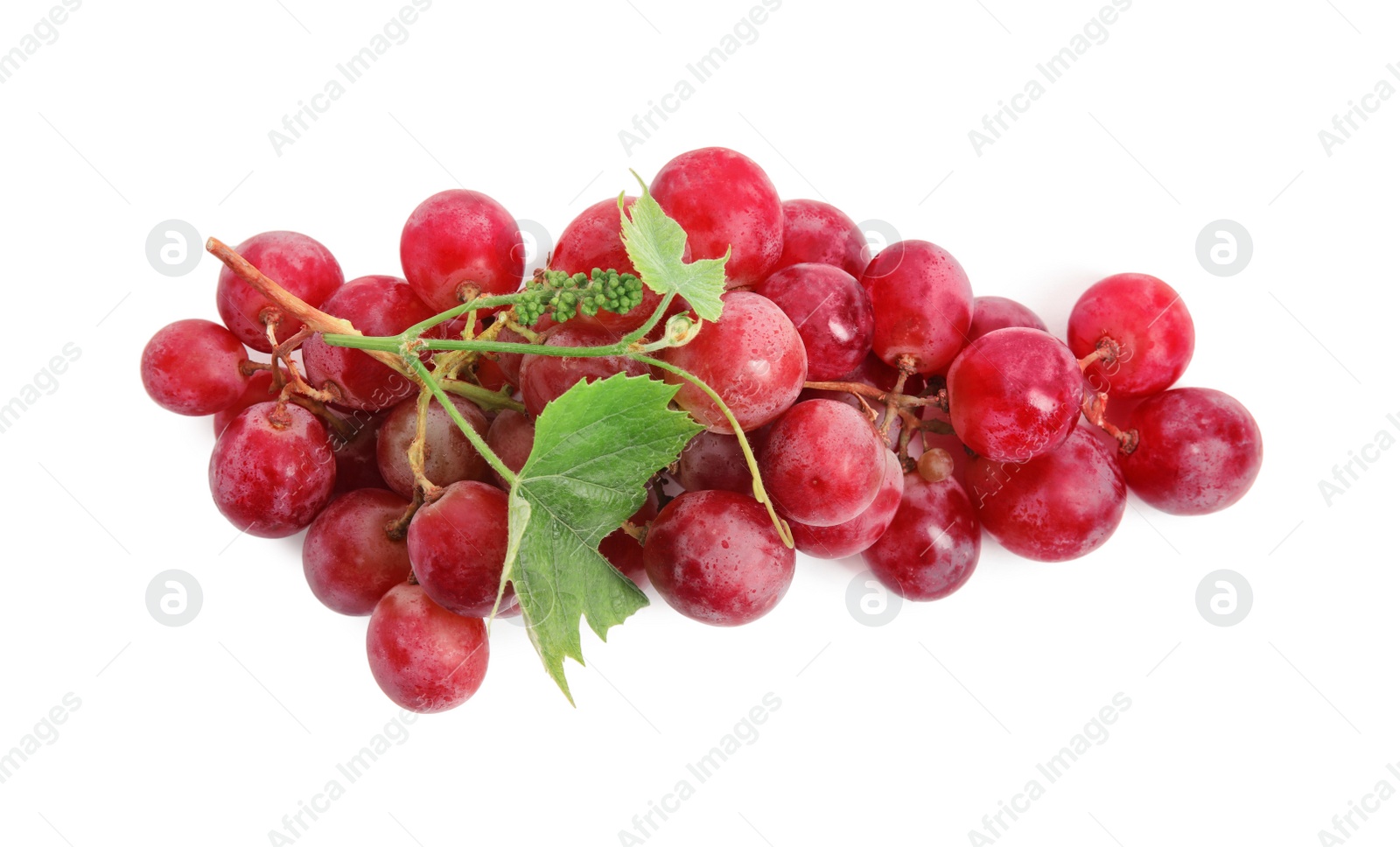 Photo of Cluster of ripe red grapes with green leaves on white background, top view