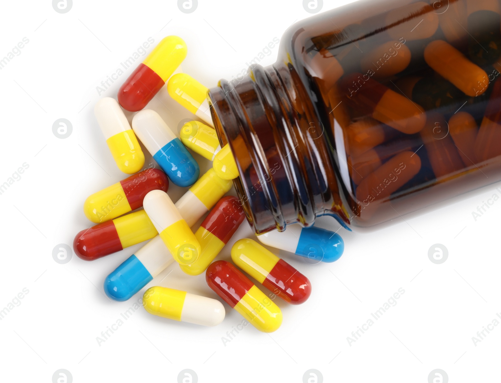 Photo of Antibiotic pills and bottle isolated on white, top view