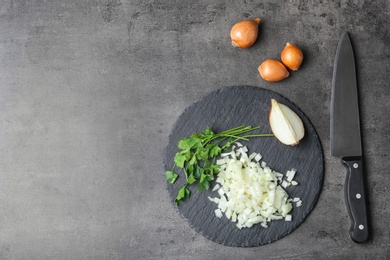 Slate plate with fresh chopped onion on table, top view