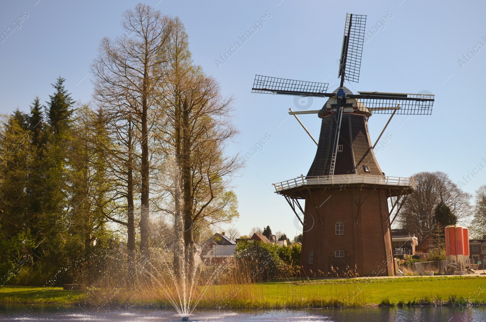Photo of Park with fountain and windmill on sunny day