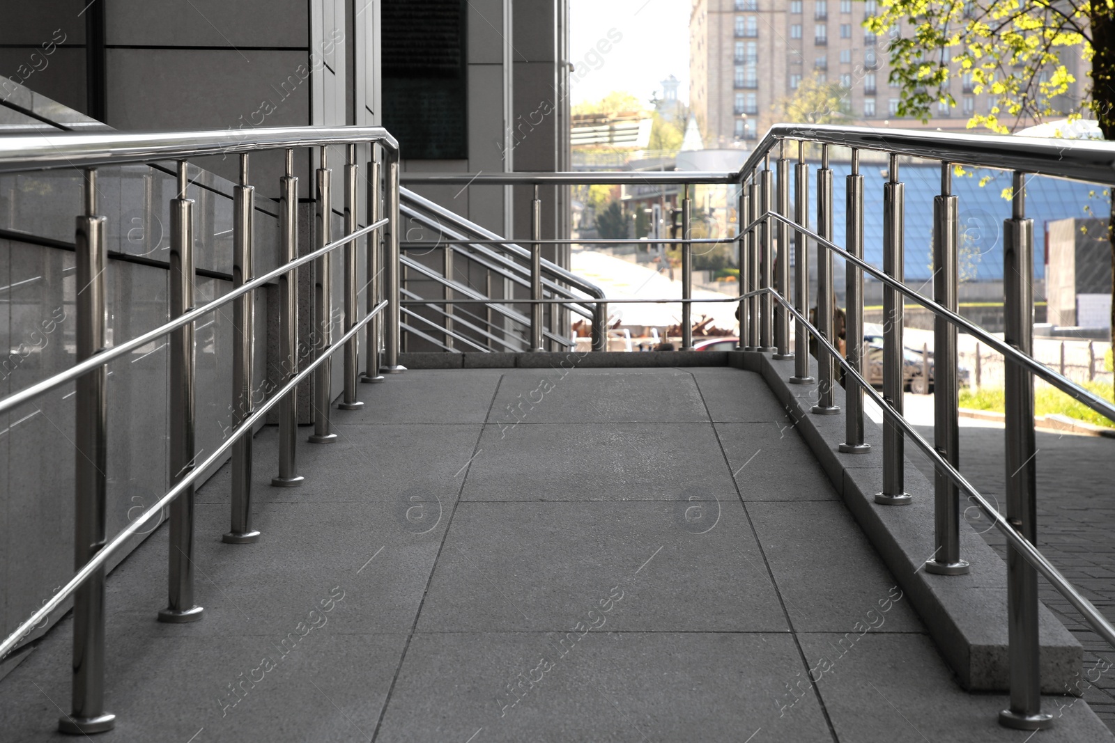 Photo of Ramp with metal handrails near building outdoors