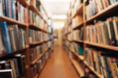 Photo of Blurred view of cabinets with books in library