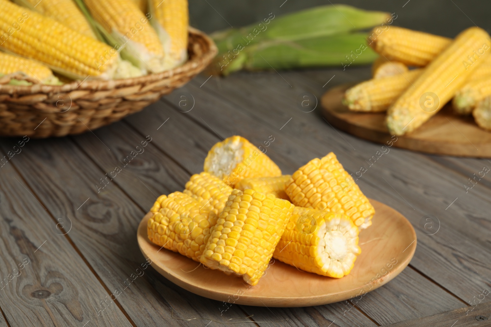 Photo of Tasty sweet corn cobs on wooden table