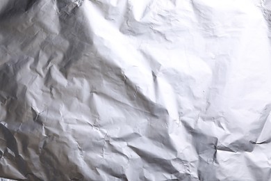 Crumpled silver foil as background, closeup view