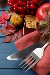 Festive table setting with autumn decor on blue wooden background, closeup