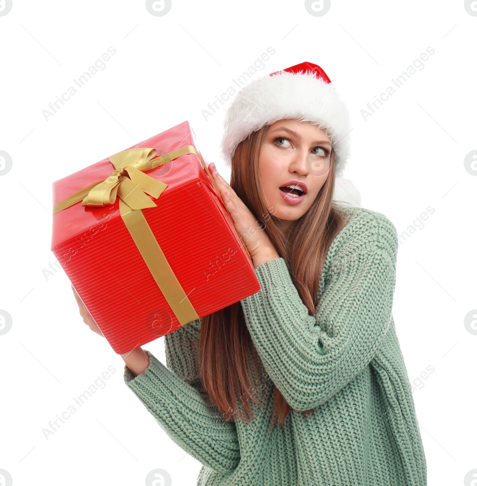 Photo of Emotional young woman in Santa hat with Christmas gift on white background