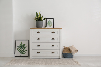 Stylish chest of drawers in living room interior