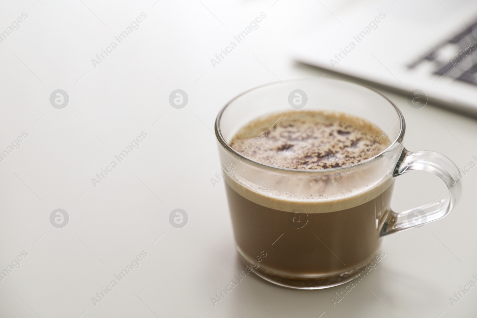 Photo of Cup of hot coffee on white table indoors in morning. Space for text