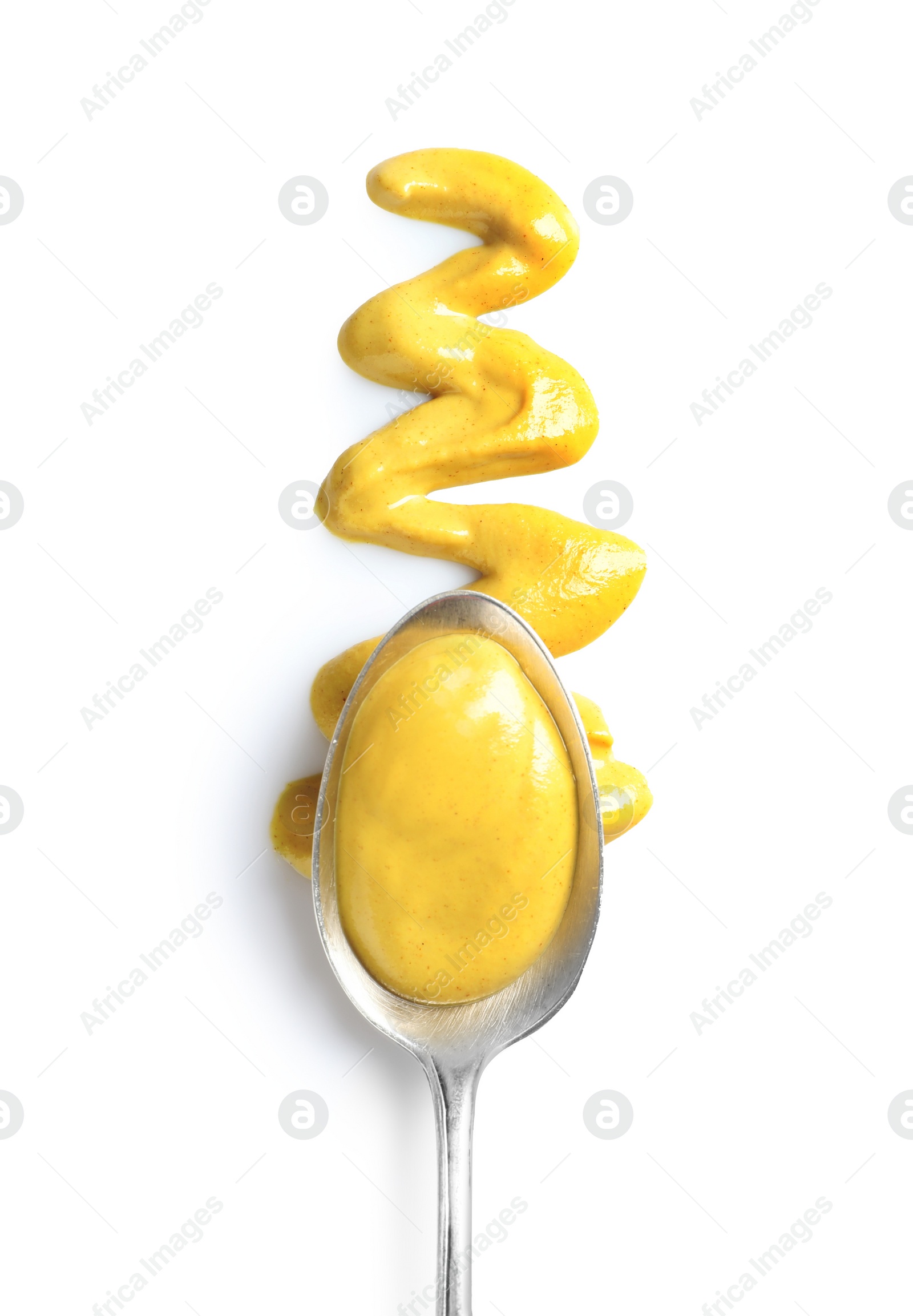 Photo of Delicious mustard and spoon on white background, top view. Spicy sauce