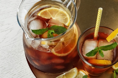 Jug and glass of delicious iced tea, above view