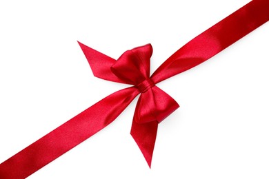 Photo of Red satin ribbon with bow on white background, top view