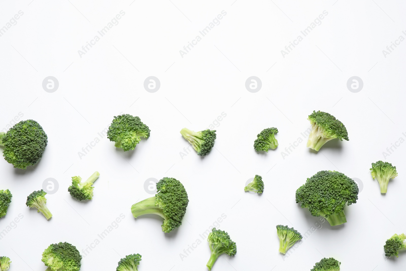 Photo of Fresh tasty broccoli on white background, top view