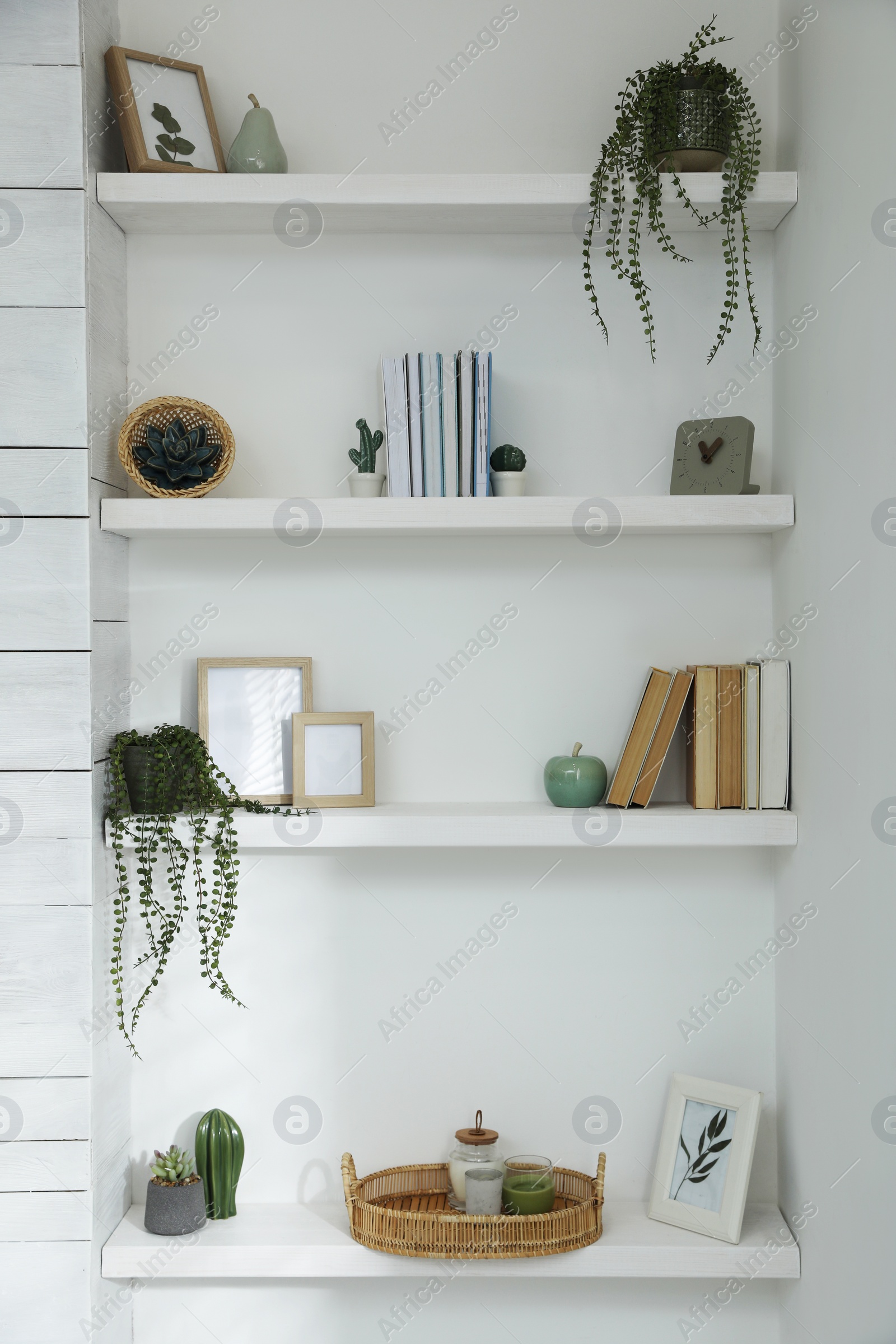 Photo of Many shelves with different decor in room. Interior design