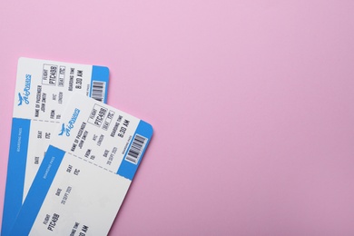 Photo of Tickets on pink background, flat lay with space for text. Travel agency concept
