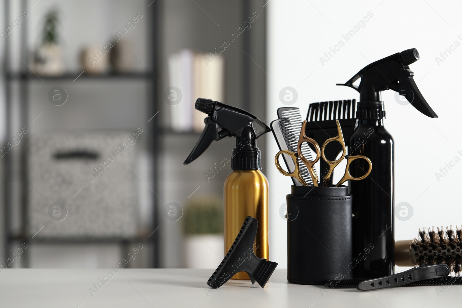 Photo of Set of hairdresser tools on table in salon, space for text