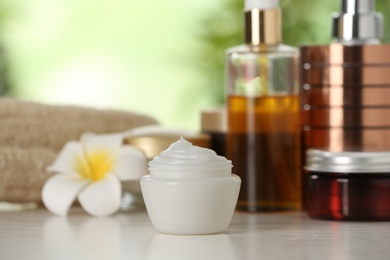 Photo of Jar of body care product on table against blurred background. Space for text