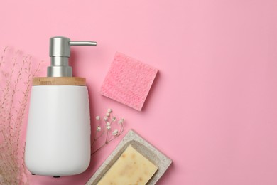 Photo of Soap bars and bottle dispenser on pink background, flat lay. Space for text