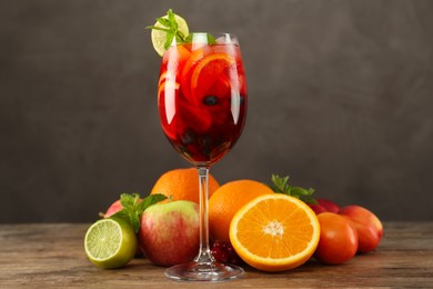 Glass of Red Sangria and fruits on wooden table