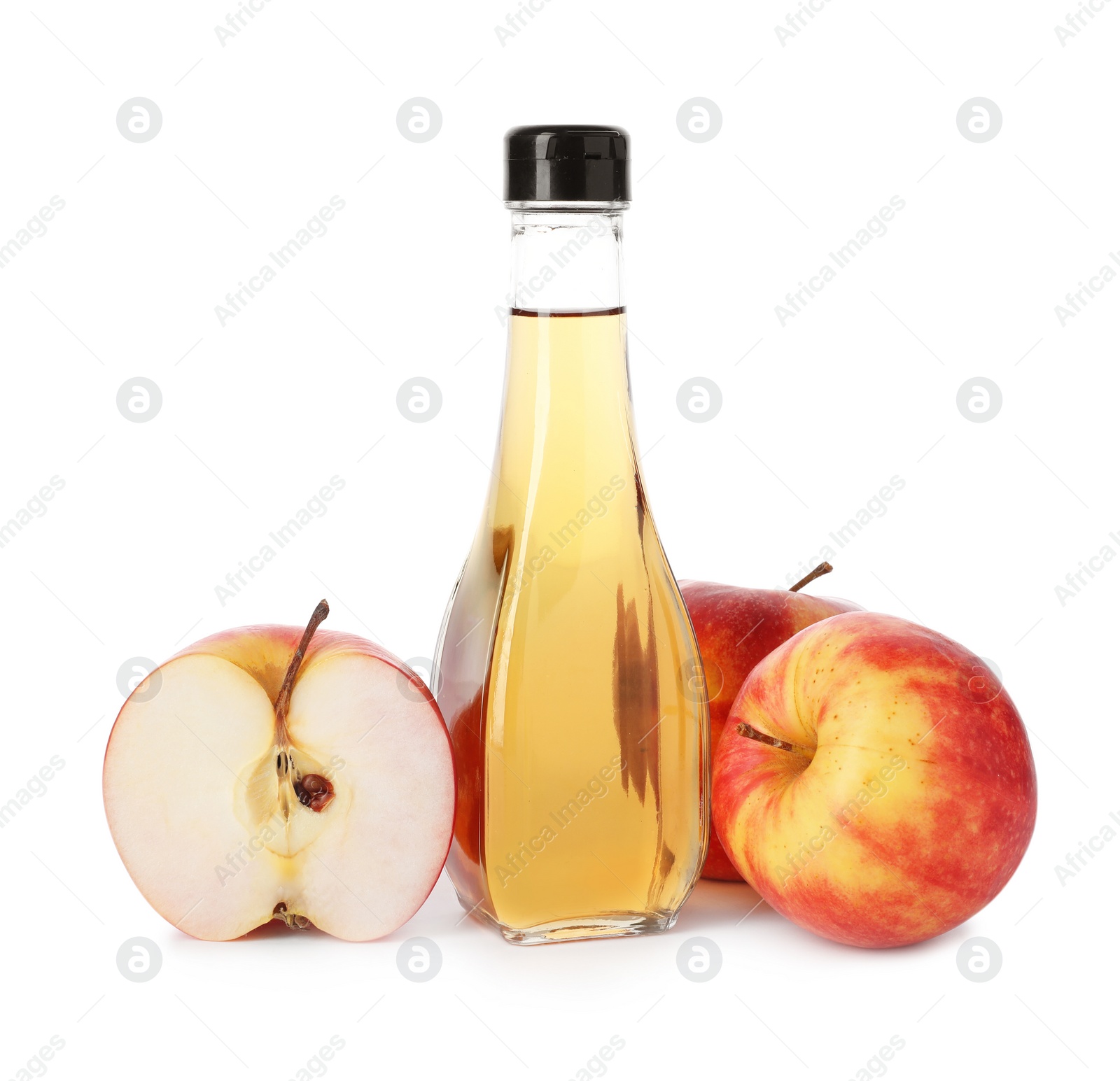 Photo of Glass bottle of vinegar and fresh apples on white background