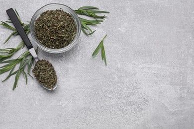 Photo of Dry and fresh tarragon on light gray textured table, flat lay. Space for text