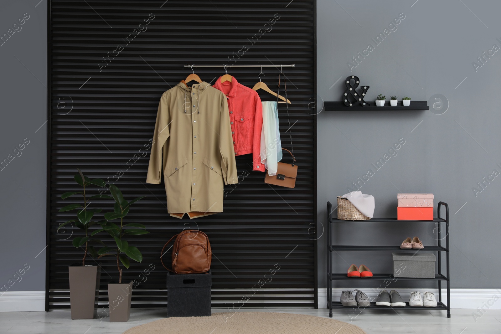 Photo of Hallway interior with stylish furniture, clothes and accessories