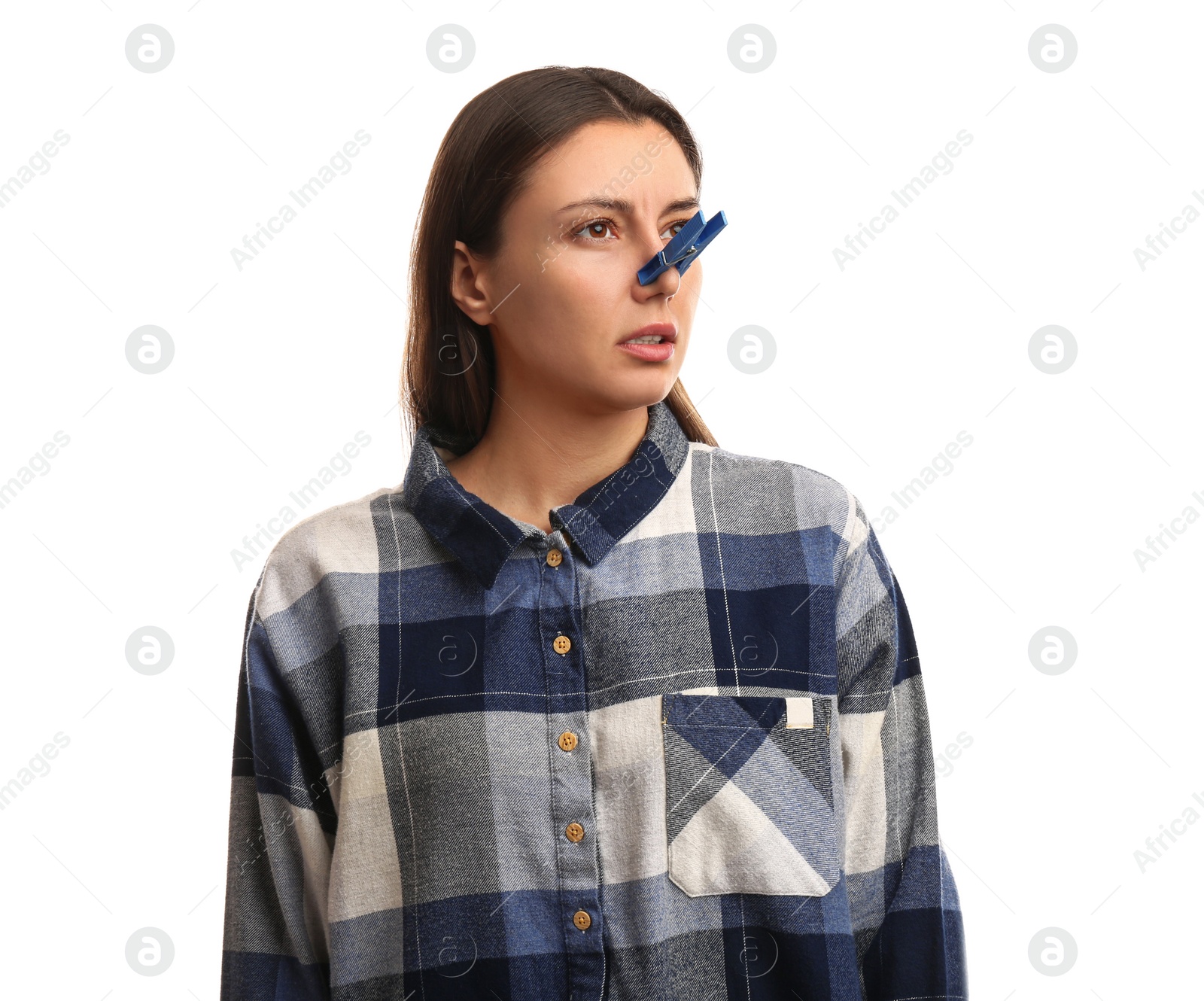 Photo of Young woman with clothespin on white background. Runny nose concept