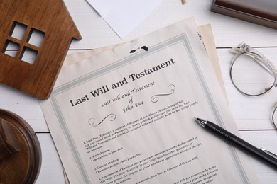 Last will and testament near house model, glasses, pen on white wooden table, flat lay