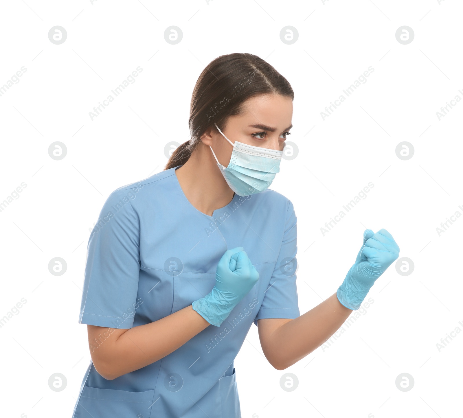 Photo of Doctor with protective mask in fighting pose on white background. Strong immunity concept