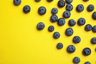 Photo of Flat lay composition with tasty blueberry and space for text on color background