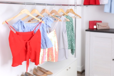 Blurred view of dressing room with different clothes and accessories