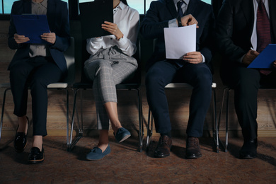 People waiting for job interview in office hall, closeup