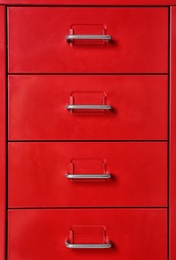 Photo of Red wardrobe drawers as background, closeup view