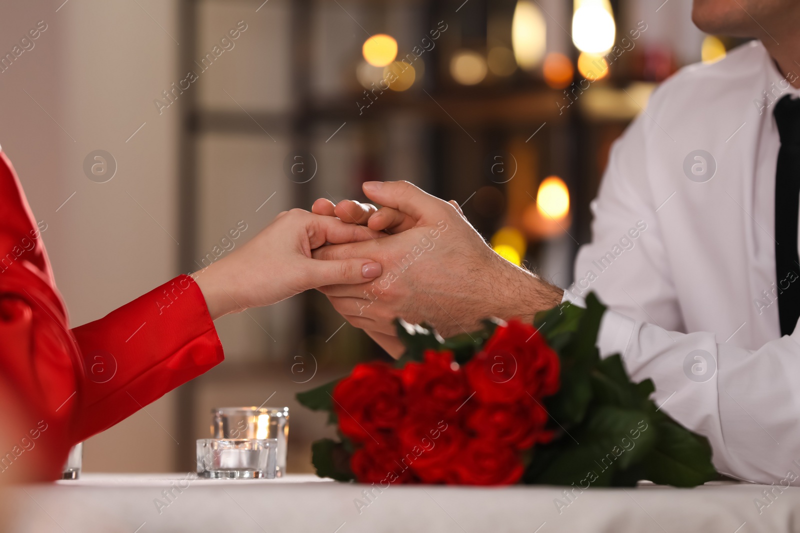 Photo of Couple having romantic dinner on Valentine's day in restaurant, closeup