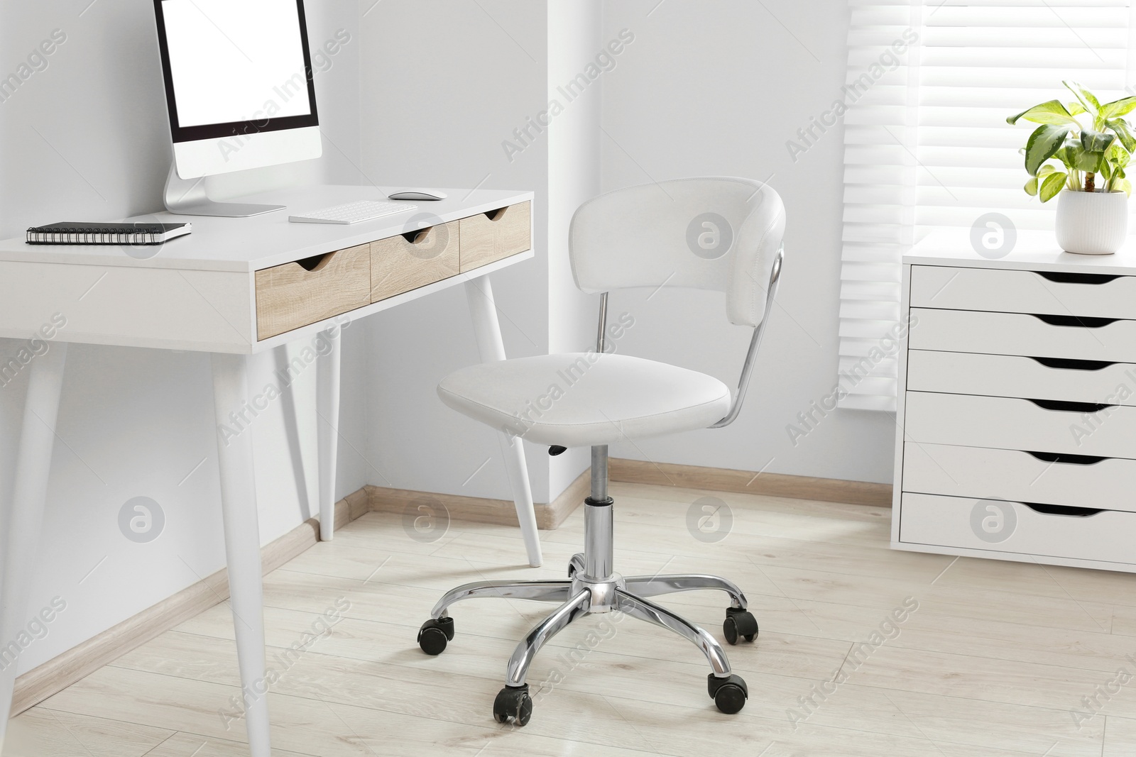 Photo of Stylish office interior with comfortable chair, desk and computer