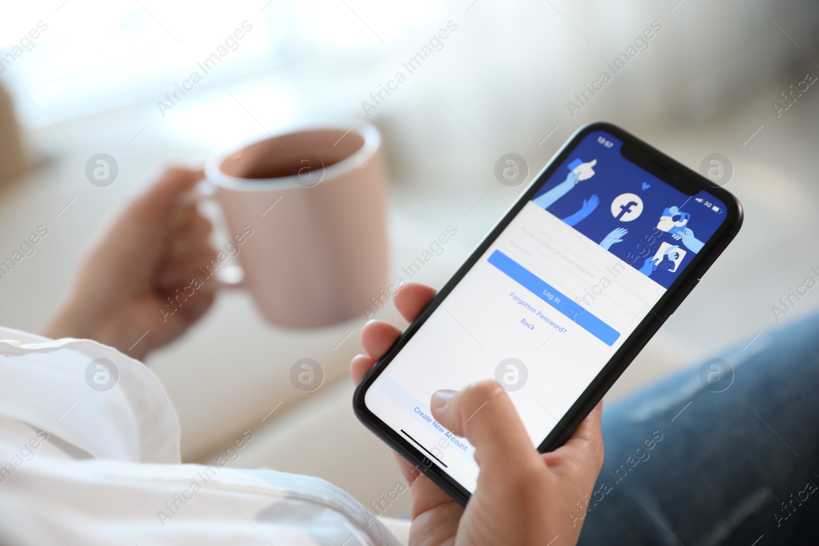 Photo of MYKOLAIV, UKRAINE - MARCH 16, 2020: Woman holding iPhone 11 with Facebook app on screen indoors, closeup